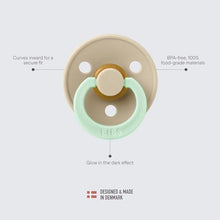 Light beige pacifier with mint shield and round nipple, glow-in-the-dark design