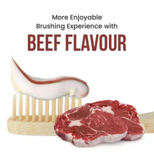 Toothbrush with beef-flavored toothpaste smear and raw beef steak pieces