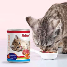 Bioline canned cat food can for beef & vegetables, beside a cat eating