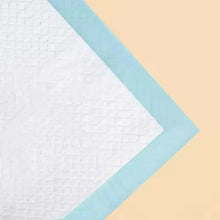Blue training pad with white quilted surface and light-blue layered border