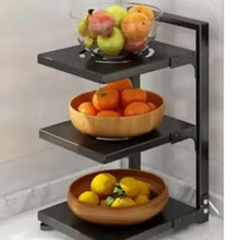 3-shelf pot rack organizer with black shelves holding fruits and cookware items