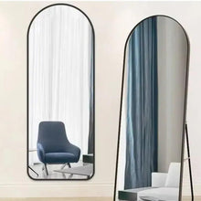 Full-length floor mirror with black aluminum arched frame and reflective glass panel
