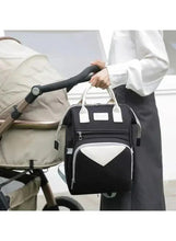 Baby travel backpack with front zip pocket and white contrast triangular panel