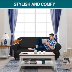 Huitich black elastic sofa cover on a living room sofa with a man using a tablet and a cat sitting on the armrest