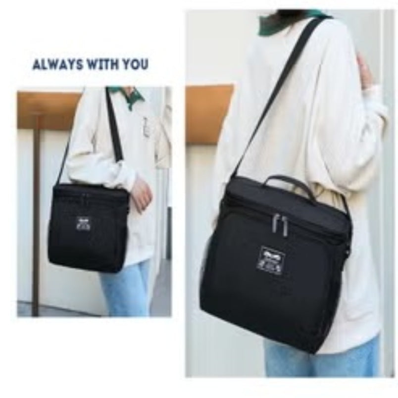 Huitich black leak proof lunch box with adjustable shoulder strap carried by person