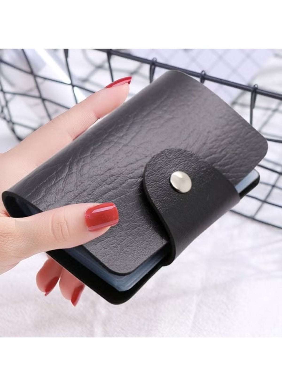 Huitich black multi card holder wallet with snap button closure held in hand