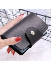 Huitich black multi card holder wallet with snap button closure held in hand