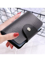 Huitich black multi card holder wallet with snap button closure held in hand