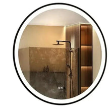Black round wall mirror with illuminated ring edge, mounted on wall