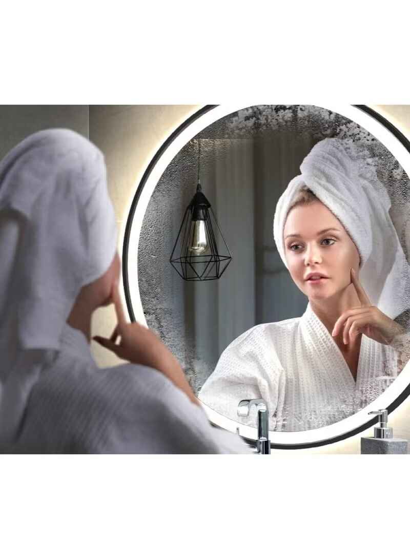 Huitich black round wall mirror with lights showing woman with towel on head reflecting in mirror