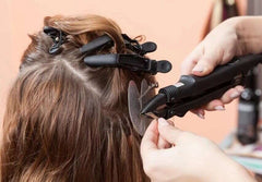 Black styling hair clips in alligator shape securing hair sections during a hair styling process