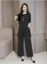 Black three-piece suit with blazer and tunic top, paired with wide-leg trousers
