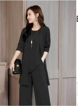 Black three-piece suit with open blazer over tunic top, styled with wide-leg trousers