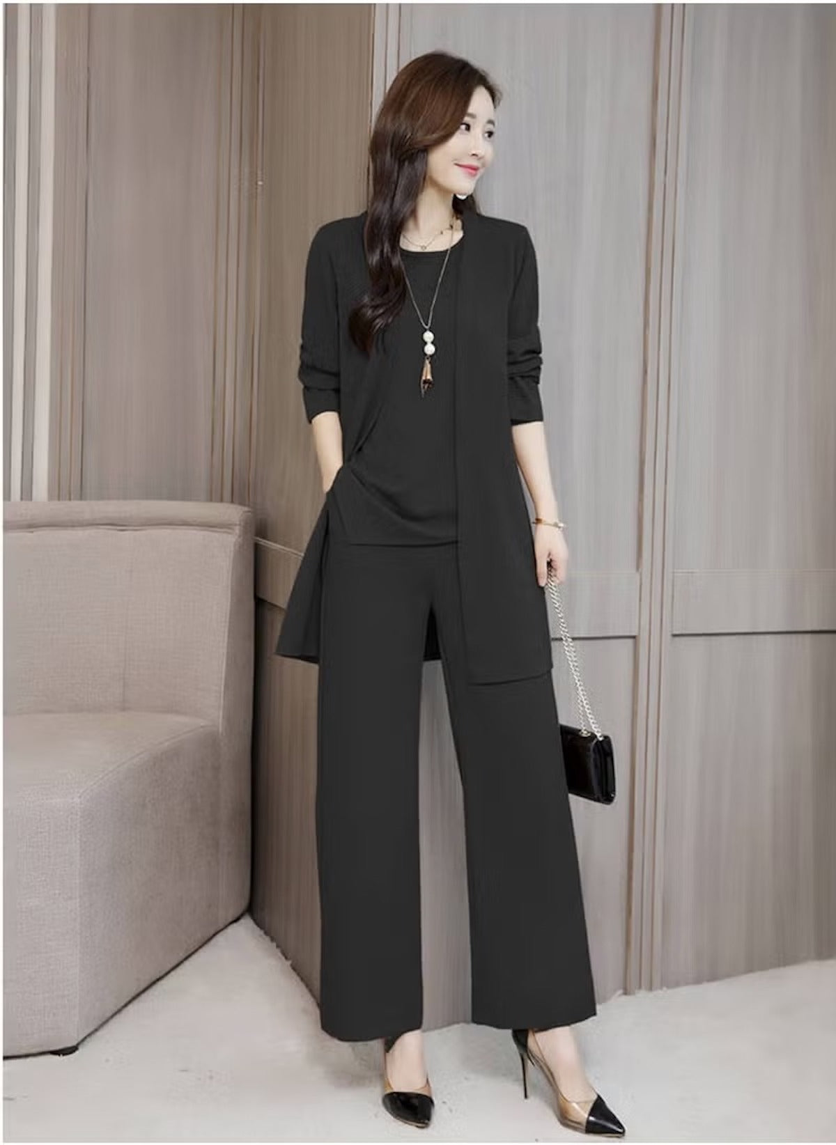 Elegant black three-piece slim suit for women featuring a long blazer, top, and wide-leg pants