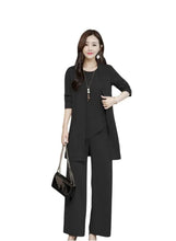 Black three-piece suit: open blazer, tunic top, and wide-leg trousers