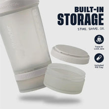 Smoke gray shaker bottle with built-in storage container and pill tray included