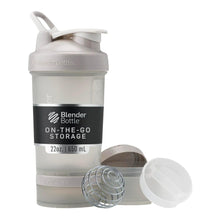 Smoke gray shaker bottle with flip cap and built-in pill organizer cup