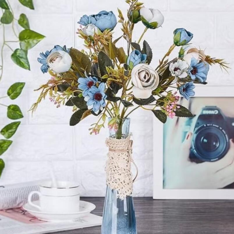 Huitich blue artificial flower bouquet in a clear glass vase with white and blue blooms on table
