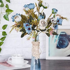 Huitich blue artificial flower bouquet in a clear glass vase with white and blue blooms on table