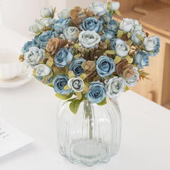 Huitich blue artificial mini roses bouquet in glass vase with mixed blue and beige flowers on white table