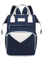 Navy baby travel backpack with white trim, top handles, front zipper pocket