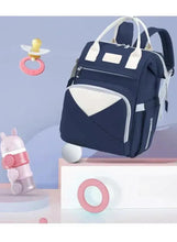 Navy baby travel backpack with white trim, side compartments, padded shoulder straps