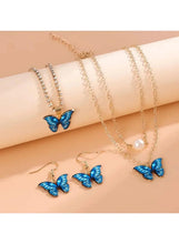 Butterfly jewelry set with gold-tone chains, pearl pendant, and blue butterfly drop charms