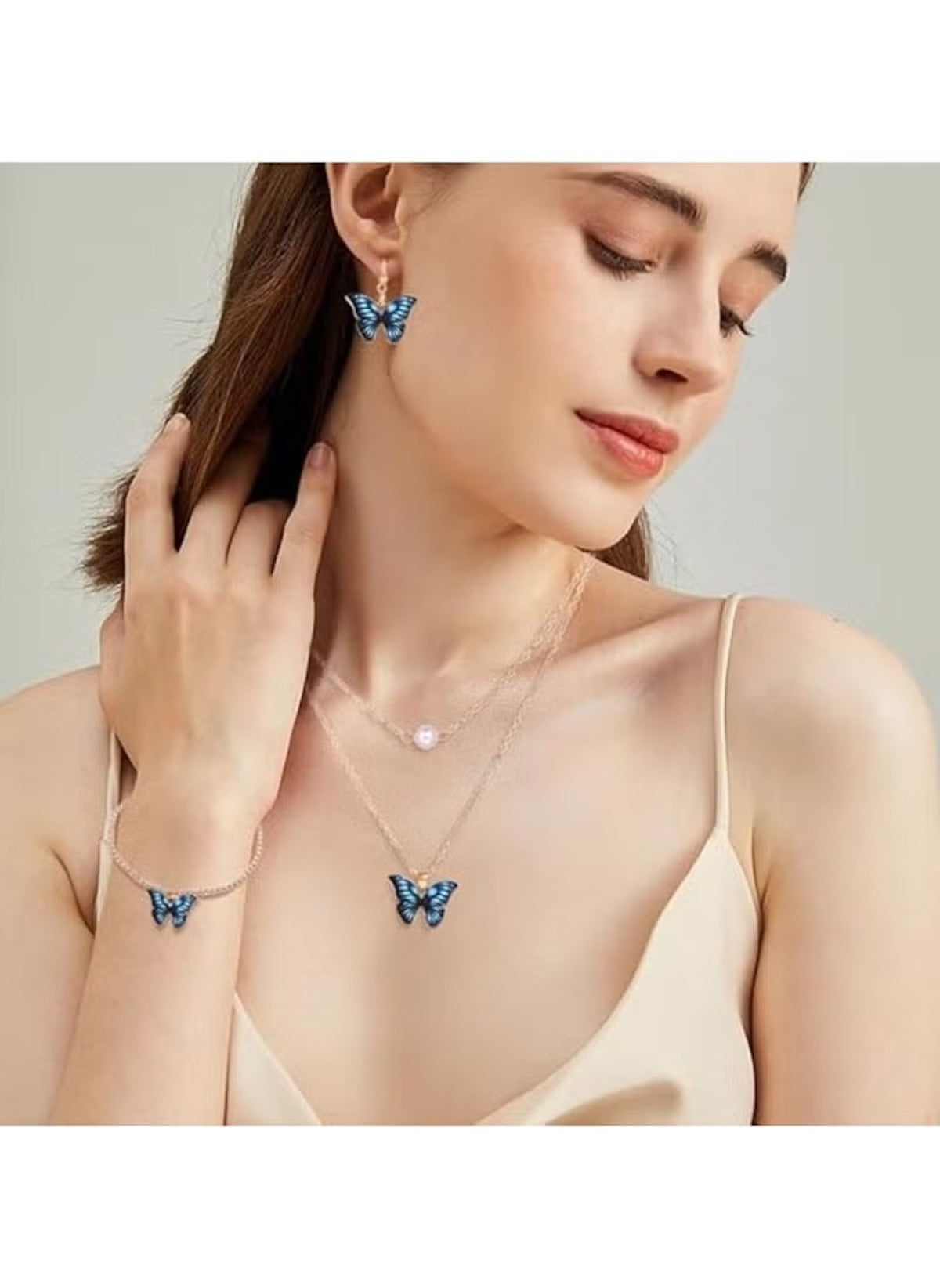 Huitich blue butterfly jewelry set including earrings, necklace, and bracelet worn by a woman