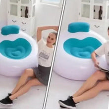 Inflatable lounge chair with teal backrest and blue seat, side view with person