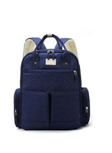 Blue quilted travel backpack with front zip pocket and central organizer
