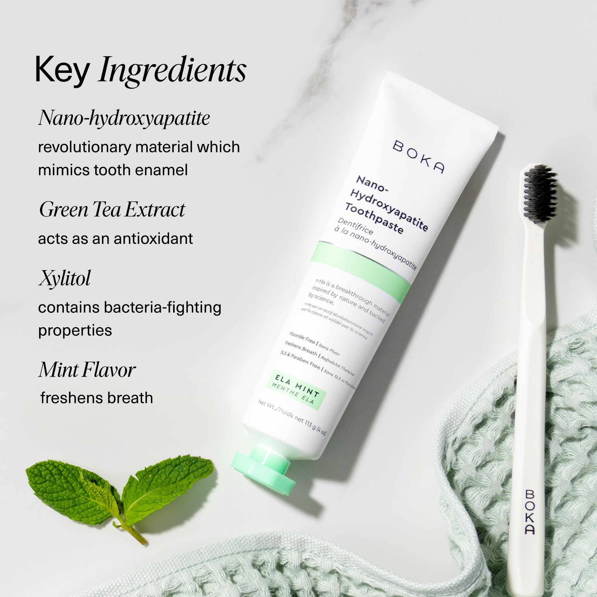 Boka nano hydroxyapatite toothpaste tube with toothbrush and mint leaves highlighting fluoride free toothpaste for sensitive teeth