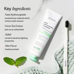 Boka nano hydroxyapatite toothpaste tube with toothbrush and mint leaves highlighting fluoride free toothpaste for sensitive teeth