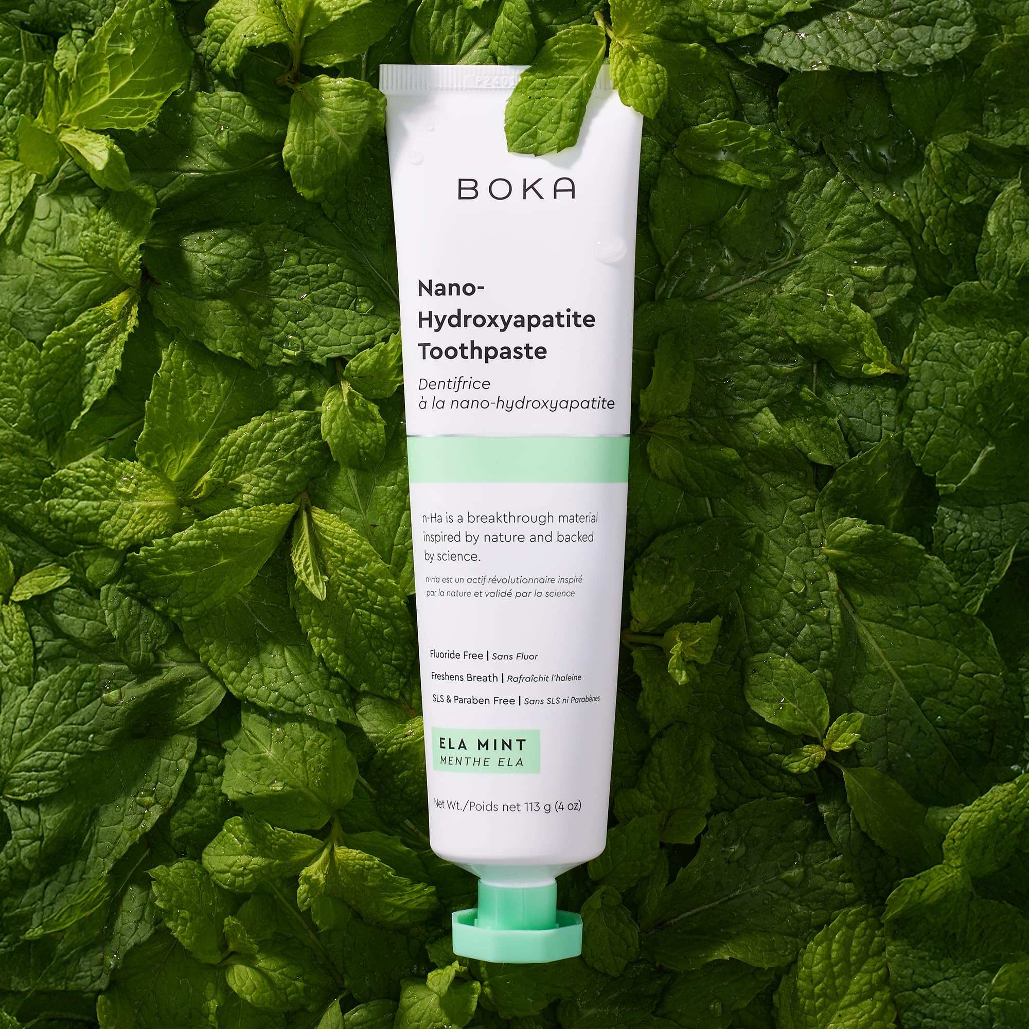 Boka Nano Hydroxyapatite Toothpaste tube on mint leaves background fluoride free toothpaste for sensitive teeth