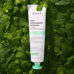 Boka Nano Hydroxyapatite Toothpaste tube on mint leaves background fluoride free toothpaste for sensitive teeth