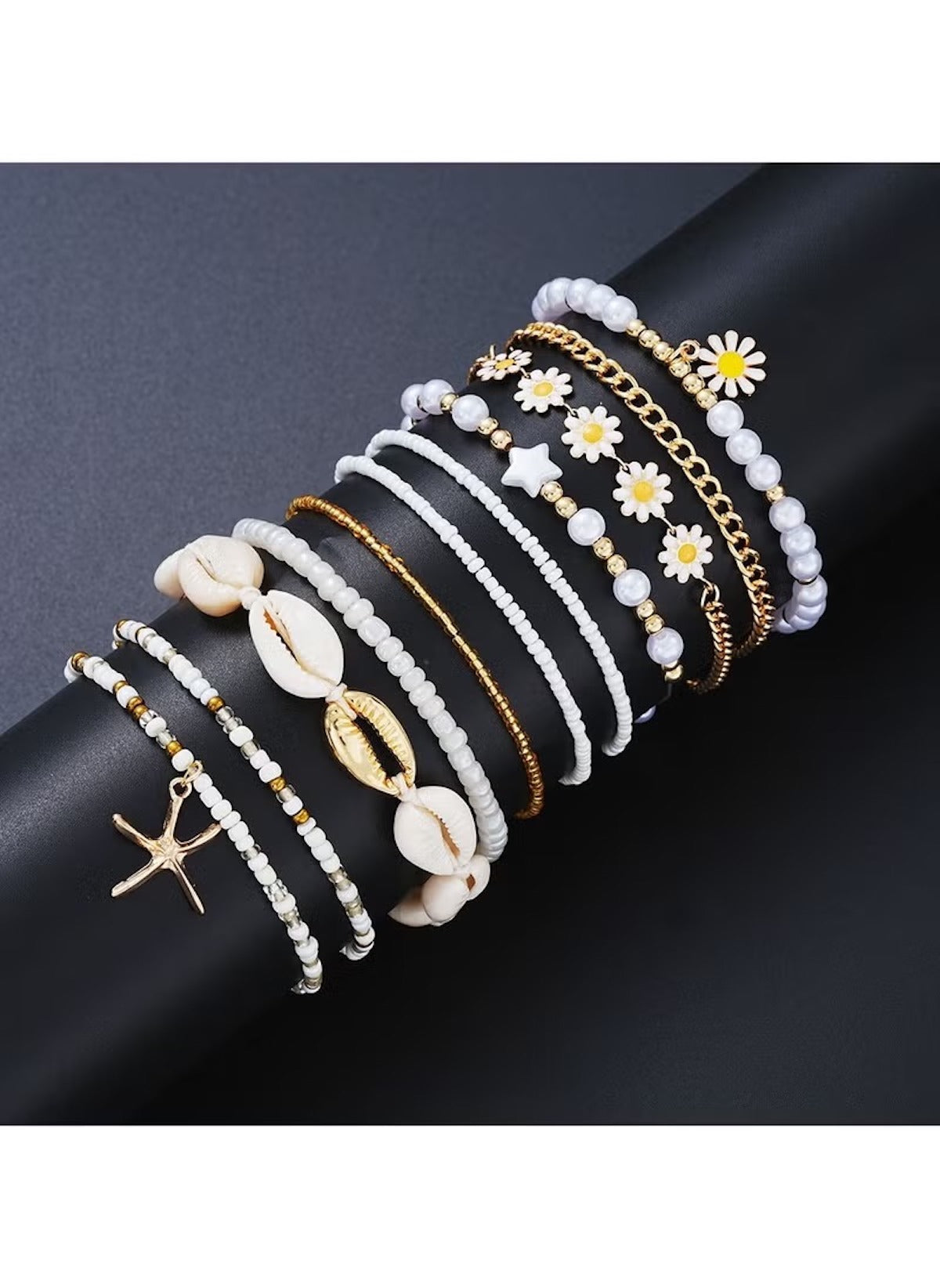 Huitich 14 piece layered beach jewelry set featuring white beads, gold chains, seashells, starfish, and daisy charms