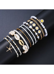 Huitich 14 piece layered beach jewelry set featuring white beads, gold chains, seashells, starfish, and daisy charms