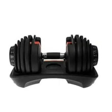 Adjustable dumbbells on a black stand, chrome handle connector visible