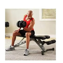 Adjustable dumbbells in hands during bench press on an incline weight bench