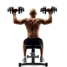 Bench setup with adjustable dumbbells held overhead