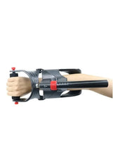 Adjustable wrist trainer worn on forearm with black padding and red strap