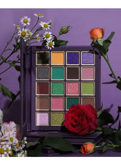 Huitich matte shimmer eyeshadow palette with vibrant purple, green, pink, and neutral shades surrounded by flowers