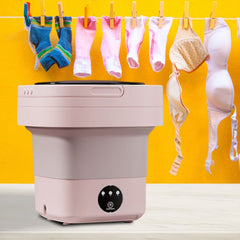 Huitich mini automatic portable washer for travel in pink with hanging socks and bras against yellow background
