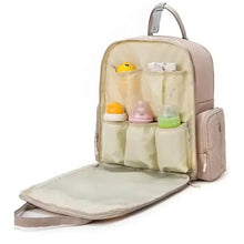 Pink diaper backpack opened to show accessory organizer and fold-out changing pad