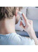 Man using a white digital ear thermometer against his ear