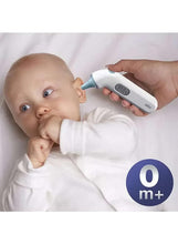White digital ear thermometer held to a baby's ear