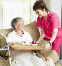 Folding wooden breakfast tray with legs being used bedside