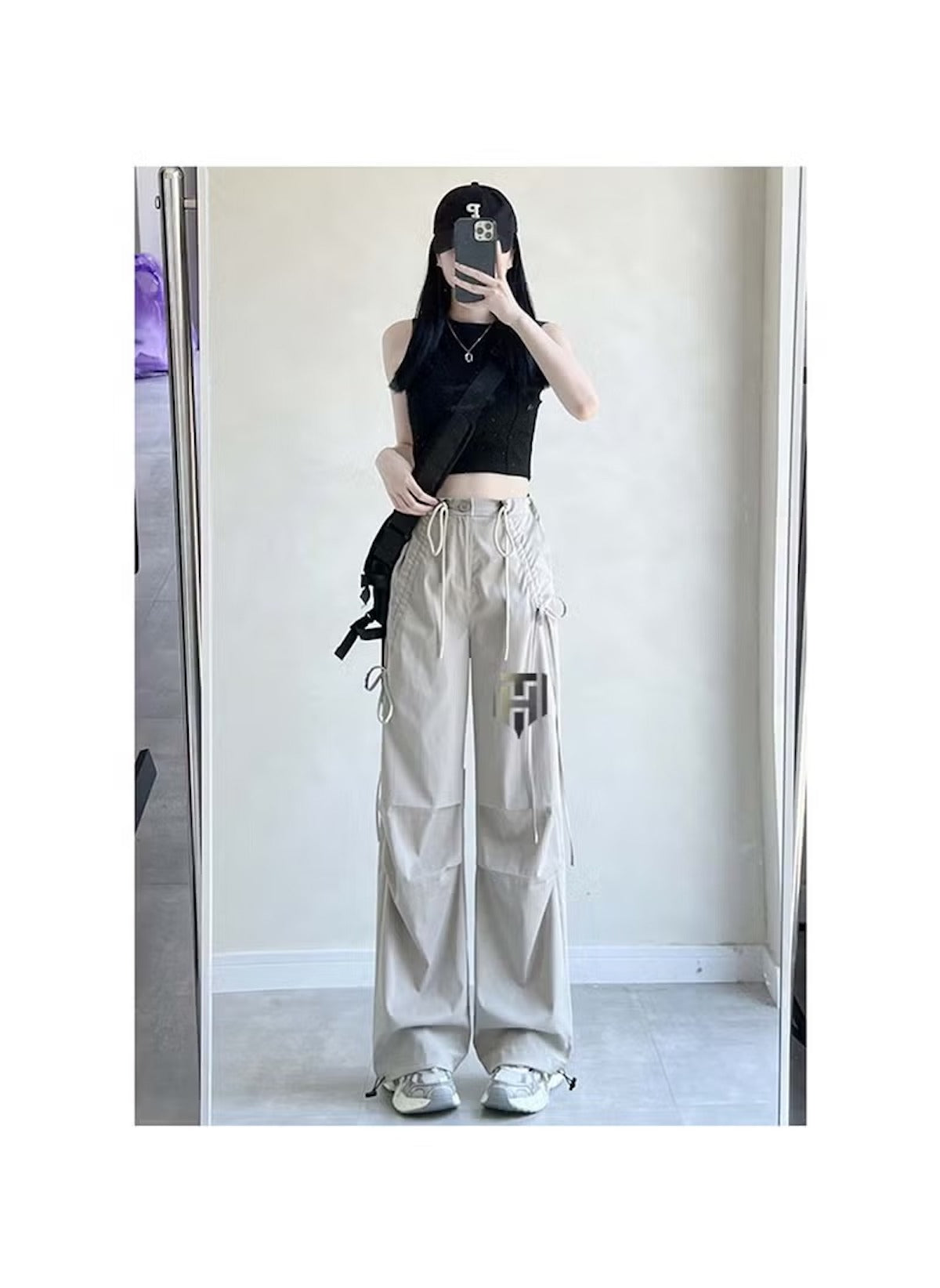 Huitich breathable flowy pants for women in beige styled with a black crop top and sneakers