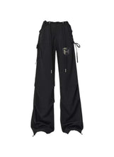 Black flowy cargo pants with drawstring waist and side tie details, wide legs