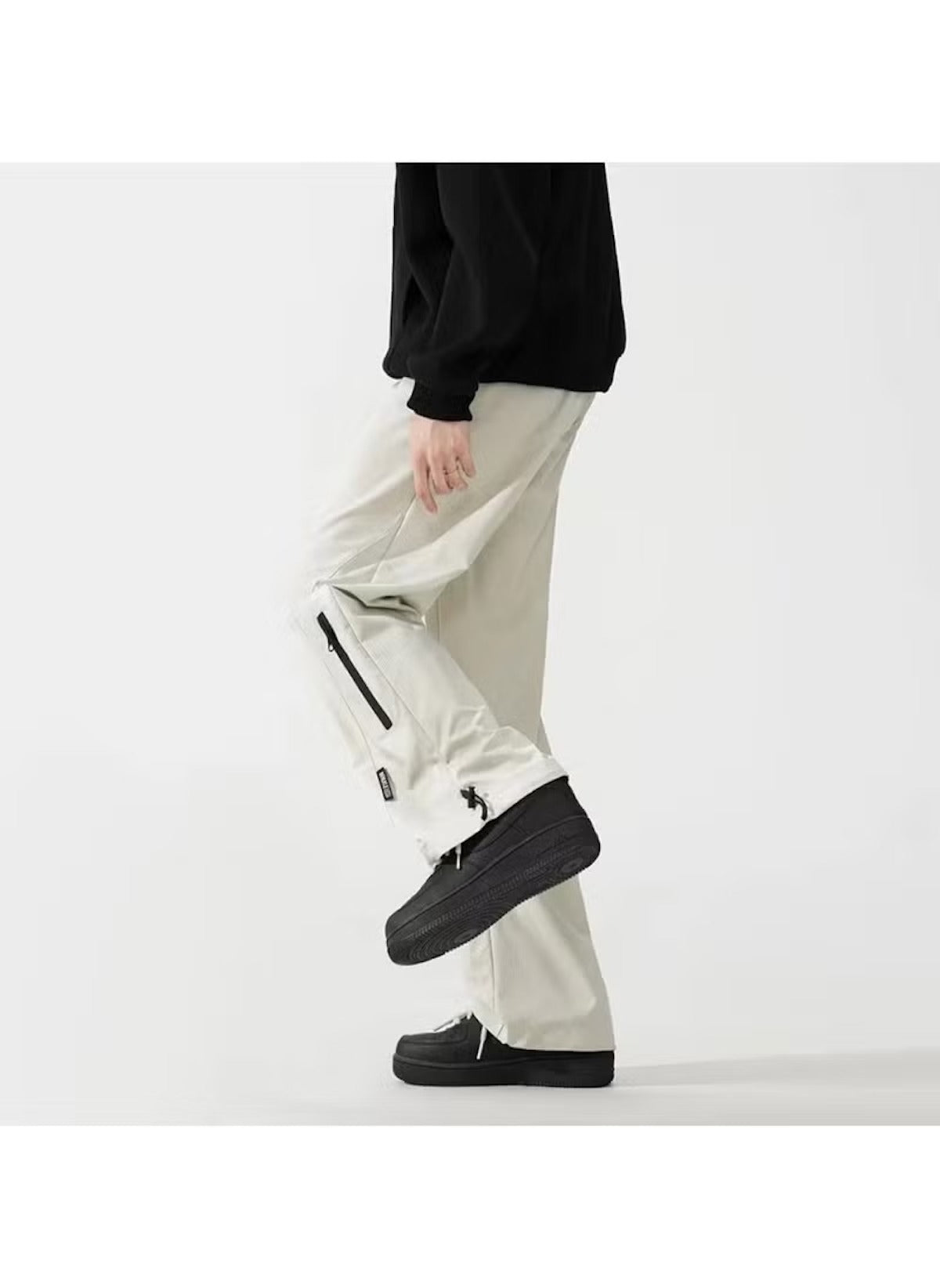 Huitich breathable outdoor pants for men in light beige with zippered leg vents and black shoes