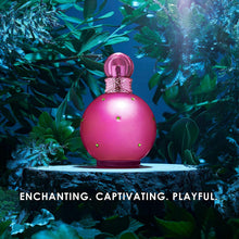 Pink perfume bottle with faceted cap on a pedestal amid blue-green foliage
